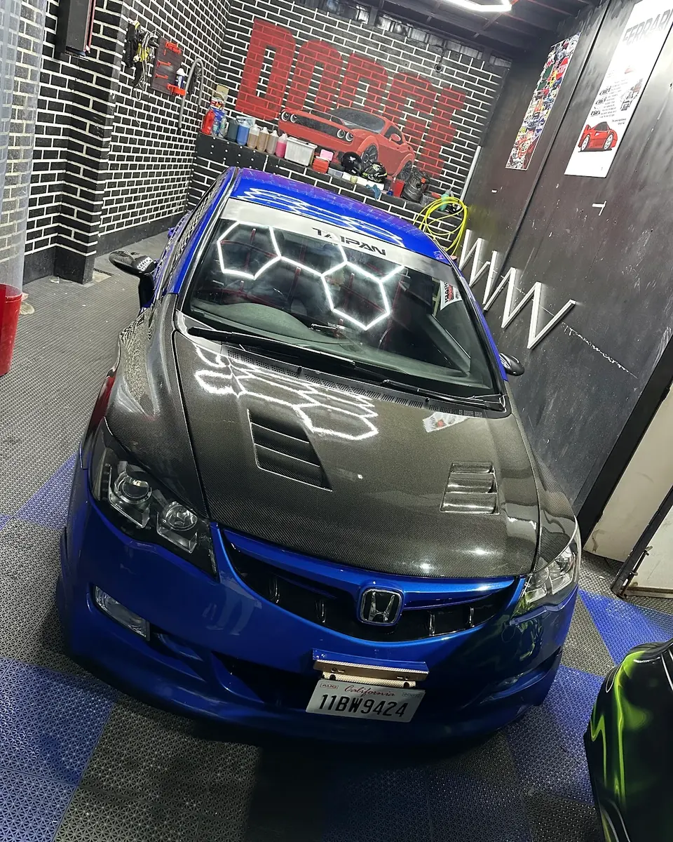 Grey and blue Honda in the detailing bay