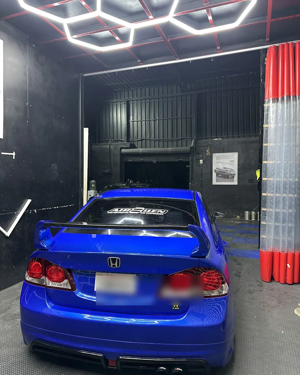 Rear of a blue Honda in the studio